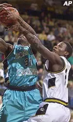 Missouri's Kareem Rush, right, gets tangled up with Coastal Carolina's Tony Darden Tuesday.