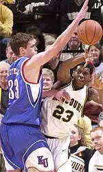 Missouri's Ricky Paulding, right, passes the ball as he is defended by Kansas' Luke Axtell, left, Monday.