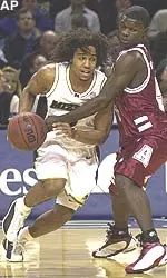 Missouri's Wesley Stokes, left, dribbles around Alabama's Antoine Pettway Tuesday night.