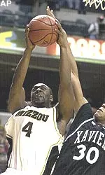 Guard Clarence Gilbert goes in for a shot against Xavier center David West in the first half.
