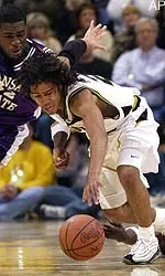 Missouri's Wesley Stokes, center, battles Kansas State's Richie Terry, left, for a loose ball.