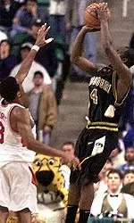 Missouri's Clarence Gilbert, right, hits the winning shot over Georgia's Rashad Wright (3) with .09 seconds left in the NCAA East Regional first round.