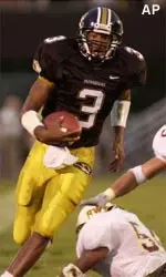Quarterback Darius Outlaw gets past Southwest Texas during the first half of their 40-6 win Saturday.