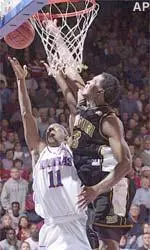 Missouri forward Najeeb Echols blocks a shot by Kansas guard Aaron Miles during the first half of their game Monday.