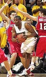 Missouri's Arthur Johnson, center, squeezes between Nebraska's Jake Muhleisen, right, and John Turek as he looks to pass during the first half.