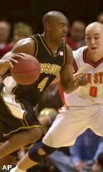Iowa State's Jake Sullivan defends as Missouri's Clarence Gilbert drives to the basket during the first half.