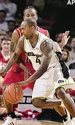 Clarence Gilbert drives past Iowa State's Ricky Morgan in the first half of their first-round game of the Big 12 Conference tournament.