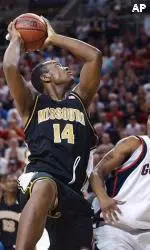 Kevin Young grabs a rebound in front of Gonzaga's Tony Skinner in the first half.