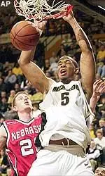 Travon Bryant, right, dunks the ball over Nebraska's Brian Conklin, Tuesday night.