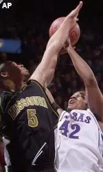 Kansas forward Jeff Graves shoots over Travon Bryant during the first half on Monday.