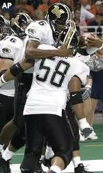 Quarterback Brad Smith celebrates with teammate Cliff Young after running in a two-point conversion in the fourth quarter against Illinois.