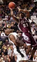 Arthur Johnson draws a charge against Texas A&M's Keith Blanks during the first half in Columbia.