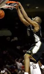Arthur Johnson dunks in front of Oklahoma center Jabahri Brown in overtime.