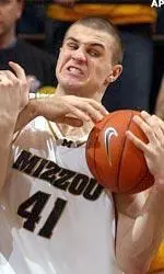 Linas Kleiza wrestles the ball away from Iowa's Greg Brunner.