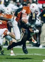 Texas defensive end Brian Robison tackles Brad Smith after Smith's rush over right end for six yards and a first down during first quarter action.