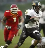 Quarterback Brad Smith carries the ball past Iowa State's Tyson Smith during a 36-yard touchdown run in the third quarter.
