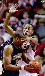 Texas Tech's Mickey Marshall defends as Missouri's Travon Bryant tries to move the ball during the first half.