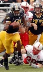 Brad Smith breaks past Nebraska's Jay Moore and Adam Carriker for a 79-yard touchdown run during the first half of Missouri's 41-24 win over Nebraska.