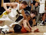 Linas Kleiza and Brian Dailey battle Colorado's Andy Osborn for a loose ball during the first half.
