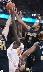 Texas's Mike Williams battles Missouri's Linas Kleiza and Jason Conley for a rebound during first half.