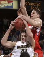 Linas Kleiza is fouled by Nebraska forward Wes Wilkinson in the last seconds of their game.
