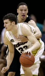 Matt Lawrence drives past Richard Roby in the first half. (AP Photo/Charlie Riedel)