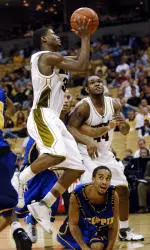 Stefhon Hannah leaps over Coppin State's Darryl Roberts during the second half of Missouri's 98-77 victory.