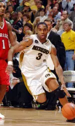 Missouri's Thomas Gardner, right, drives past Nebraska's Jason Dourisseau, left, as he heads to basket during the second half in their NCAA basketball game, Wednesday, March 5, 2006, in Columbia, Mo. Gardner led all scorers with 23 points. (AP Photo/L.G. Patterson)