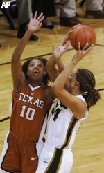 Texas' Brittainey Raven battles Missouri's EeTisha Riddle, right, for a long rebound during the first half of Wednesday's overtime contest. (AP Photo/L.G. Patterson)