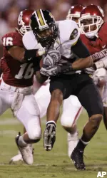 Wide receiver Danario Alexander is tied up by Oklahoma defenders Lewis Baker and Marcus Walker in the second quarter.