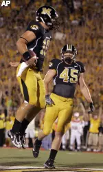 Missouri quarterback Chase Daniel, left, leaps in celebration of his touchdown run as teammate Chase Coffman looks on during the first quarter. (AP Photo/Jeff Roberson)