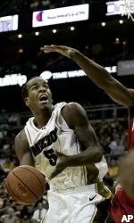 Forward Leo Lyons prepares to shoot under pressure from Maryland forward Dino Gregory during the first half.