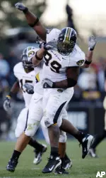 Defensive lineman Lorenzo Williams celebrates after recovering a fumble by Colorado quarterback Cody Hawkins in the second quarter.