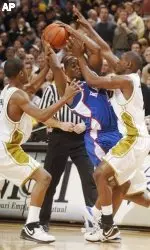 Stefhon Hannah, left, and J.T. Tiller, right, double-team Kansas' Sherron Collins in the first half.