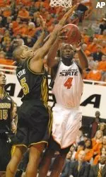 Leo Lyons blocks the shot of Oklahoma State forward Mario Boggan during the second half.