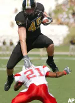 Chase Coffman leaps over Illinois State's Jason Tate after a reception during the first half. (AP Photo/L.G. Patterson)