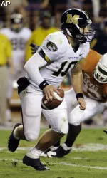 Chase Daniel scrambles away from Texas defensive tackle Lamarr Houston during the second quarter. (AP Photo)
