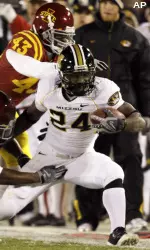 Derrick Washington looks to break away during the first half. (AP Photo)