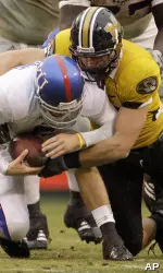 Kansas quarterback Todd Reesing is sacked by Stryker Sulak during the second quarter. (AP Photo/Charlie Riedel)