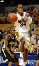 Missouri's Kim English, center, drives past Arkansas-Pine Bluff's Savalance Townsend, left, as he moves toward the basket during the second half. (AP Photo/L.G. Patterson)