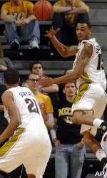Keith Ramsey saves the ball from going out of bounds as he passes to teammate Laurence Bowers during the first half. (AP Photo/L.G. Patterson)