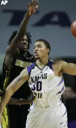 Missouri forward DeMarre Carroll (1) covers Kansas State forward Michael Beasley (30) during the first half (AP Photo)