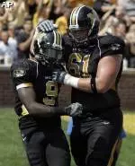 Jeremy Maclin, left, is congratulated by teammate Colin Brown after scoring on a 16-yard touchdown run during the second quarter.