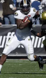 Derrick Washington fends off Colorado safety while carrying the ball for a long gain in the second quarter. (AP Photo/David Zalubowski)