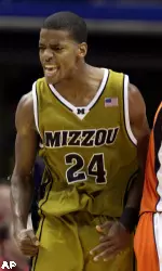 Missouri's Kim English, left, celebrates after hitting a shot as he walks past Illinois' Brandon Paul during the second half of an NCAA college basketball game Wednesday, Dec. 23, 2009, in St. Louis. English scored 24 points to lead Missouri to an 81-68 victory. (AP Photo/Jeff Roberson)