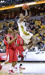 Missouri's Kim English, right, drives past Austin Peay's Eric Mosley, left, and Chris Reaves, center, as he scores two of his game-high 23 points, during the second half an NCAA college basketball game Sunday, Dec. 27, 2009, in Columbia, Mo. Missouri won 94-79.(AP Photo/L.G. Patterson)