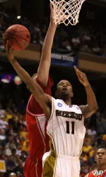 Zaire Taylor gets a shot past the reach of Cornell center Marc Van Burck during the second half. (AP Photo/Matt Cilley)