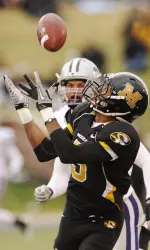 Rolandis Woodland catches the ball in front of K-State cornerback Tysyn Hartman, left, for a 51-yard gain