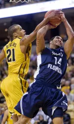 Laurence Bowers, left, blocks the shot of North Florida's Jimmy Williams Jr.