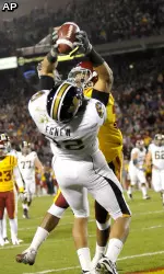 Missouri's Michael Egnew, foreground, catches a touchdown pass as Iowa State's Ter'Ran Benton defends during first half.